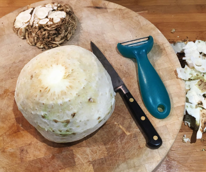 peeled celeriac on a chopping board